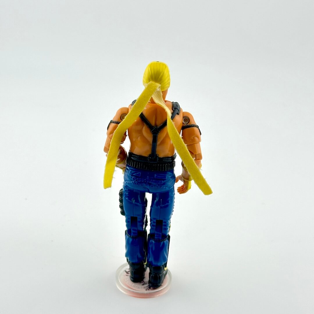 Action figure with blue pants and yellow hair on a white background