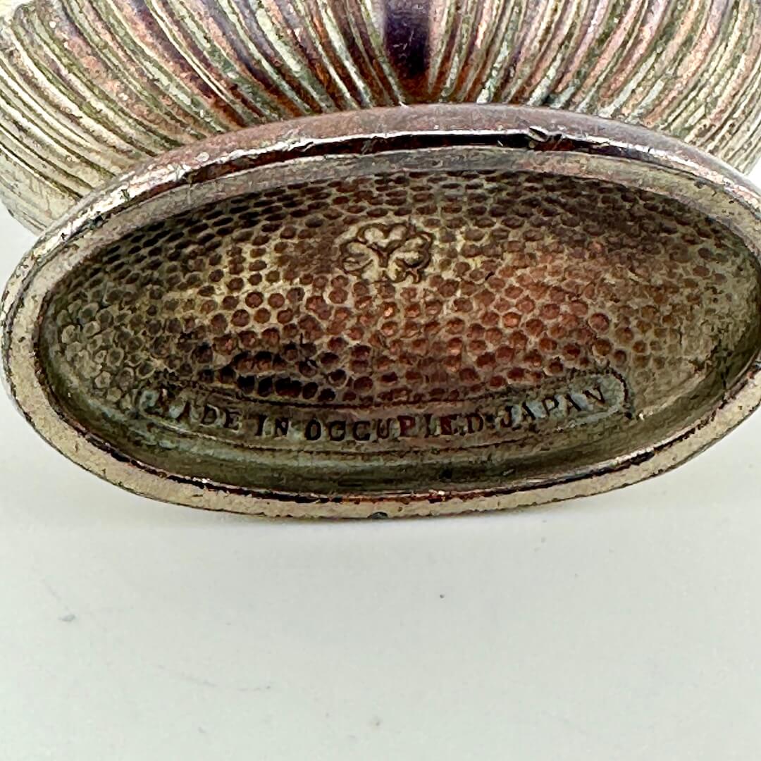 Close-up of bottom of lighter showing "Made in Occupied Japan" under floral maker's mark. 