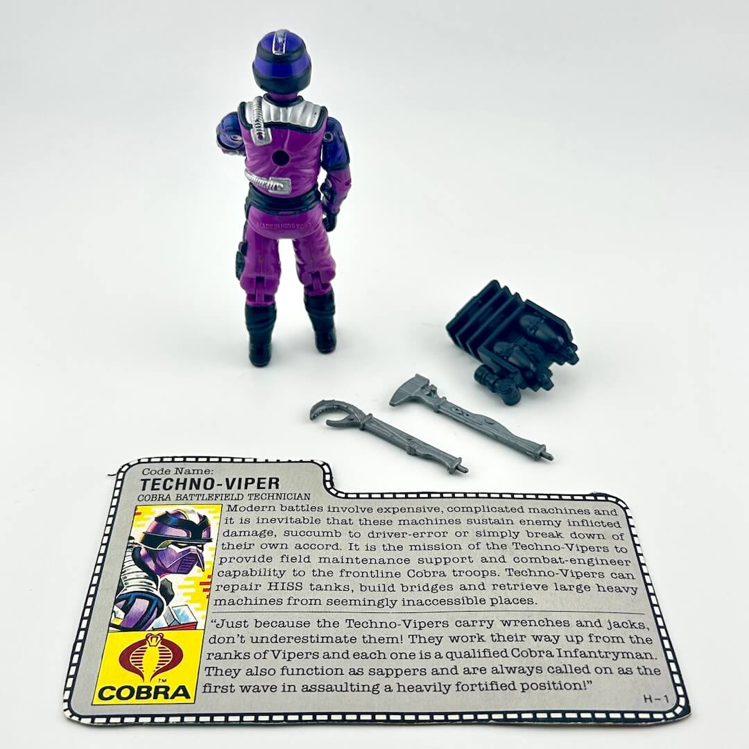 G.I. Joe action figure with accessories and character card against white background.