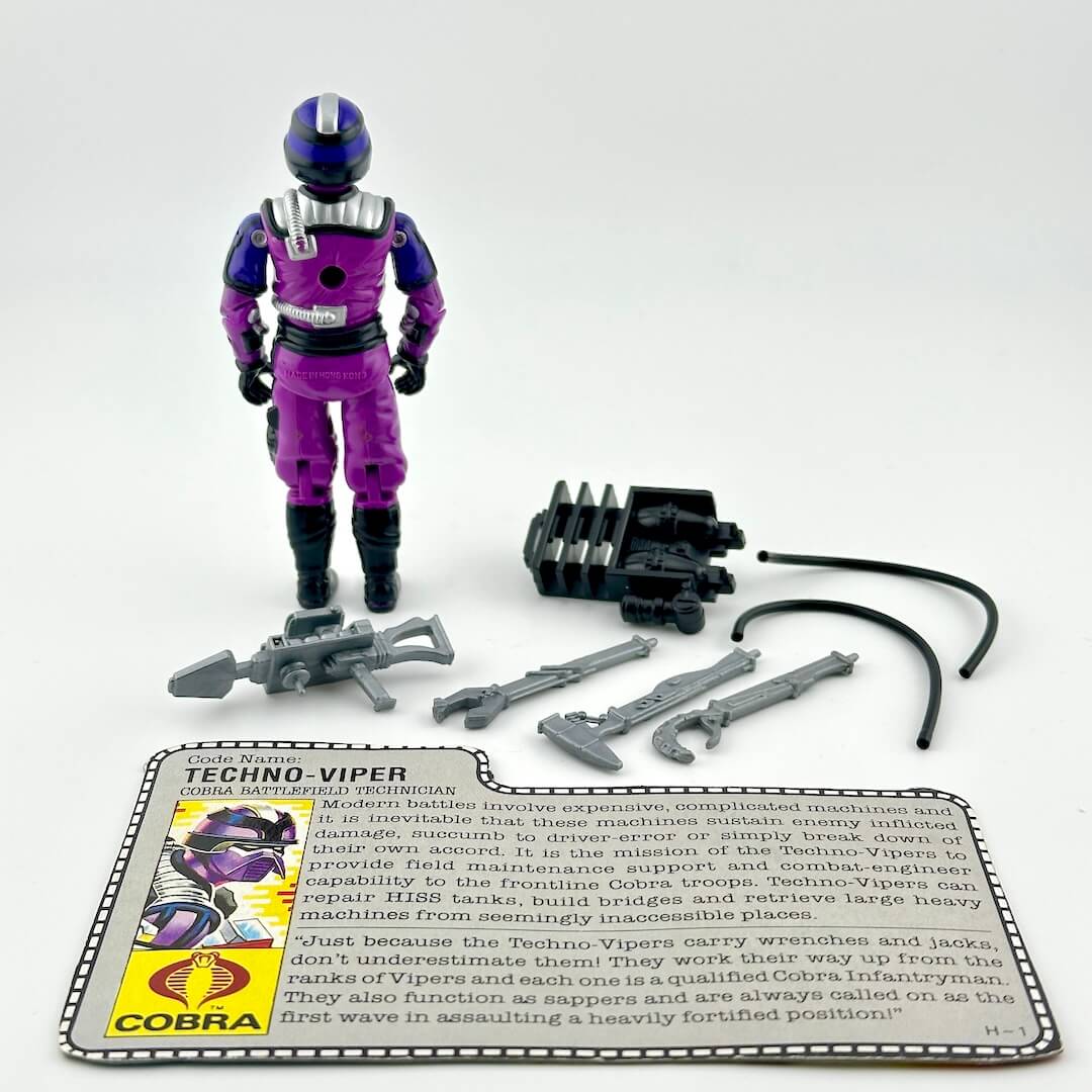 GI Joe action figure with accessories and card against white background. 
