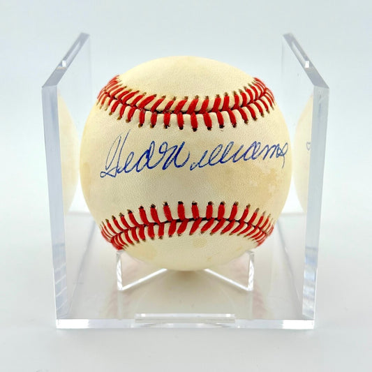 Signed baseball in clear display cube against white background. 