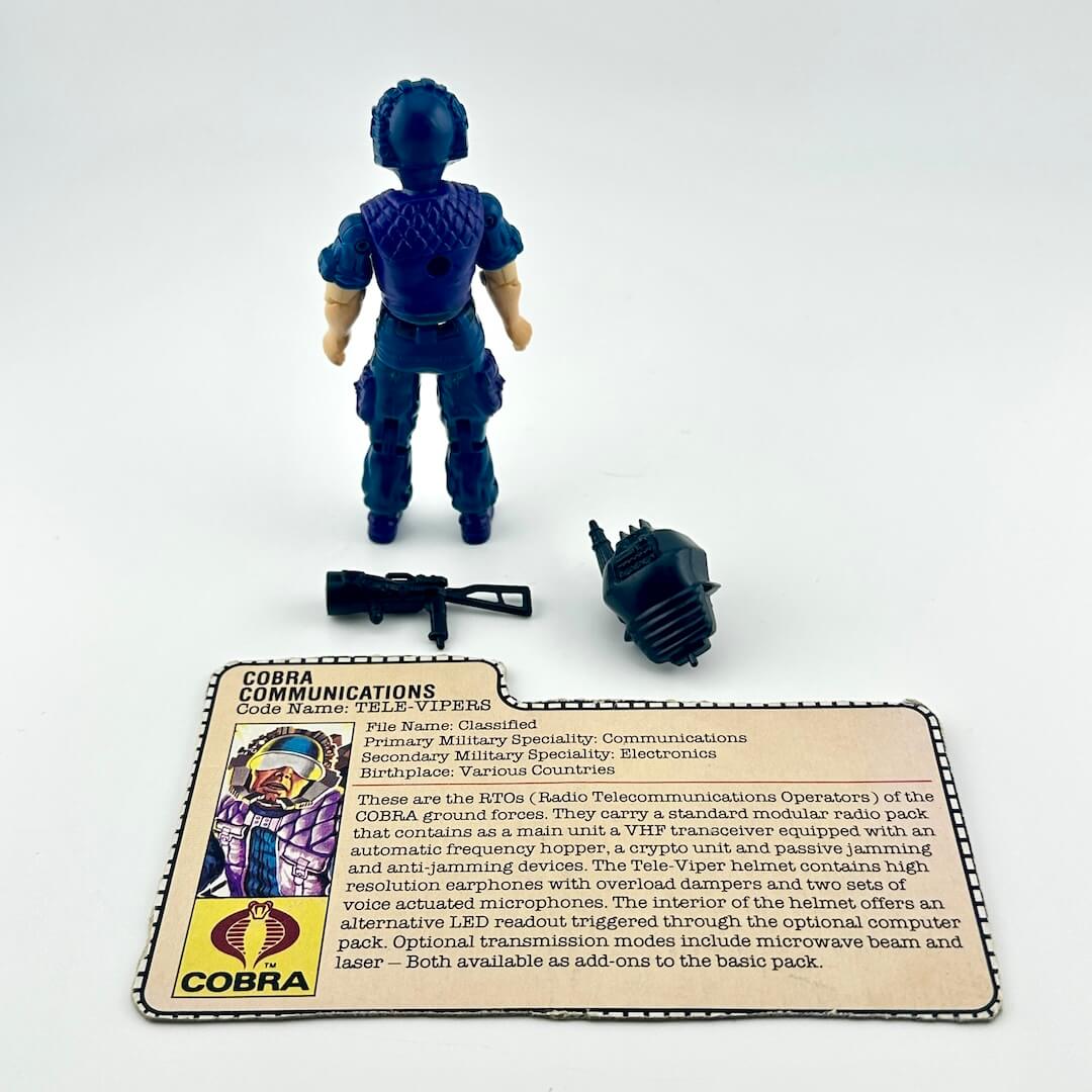 G.I. Joe action figure with accessories and character card against white background.