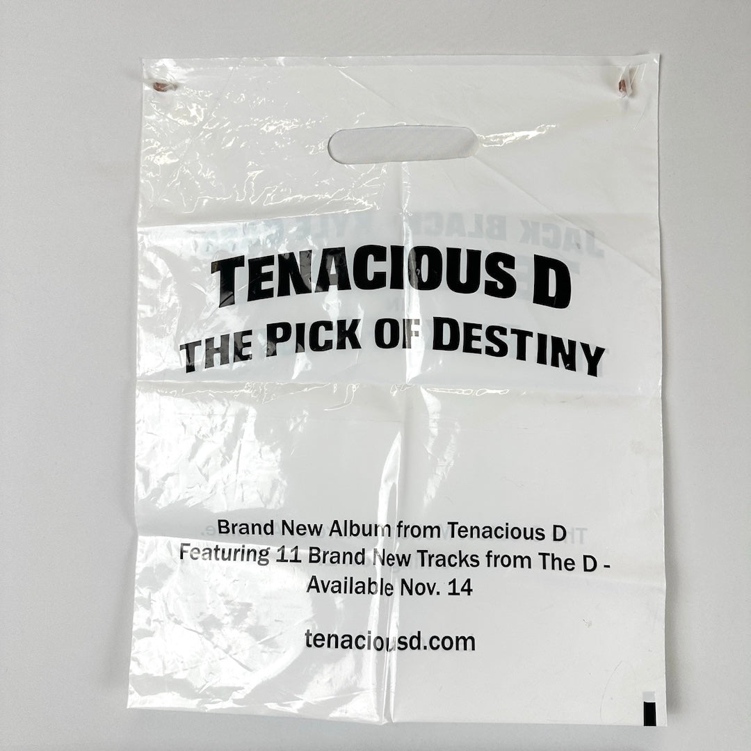 White plastic bag with black text, "Tenacious D: The Pick of Destiny" followed by album info & website.