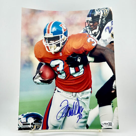 Autographed football photo of a player in an orange jersey with a helmet, holding a football.
