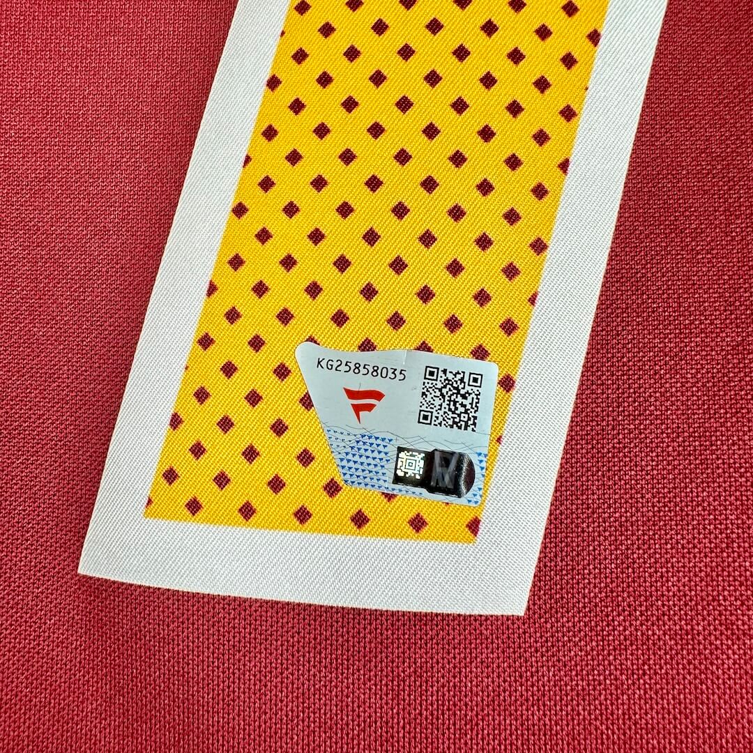 Close-up of Fanatics authentication sticker on number '17' on red and yellow football jersey. 