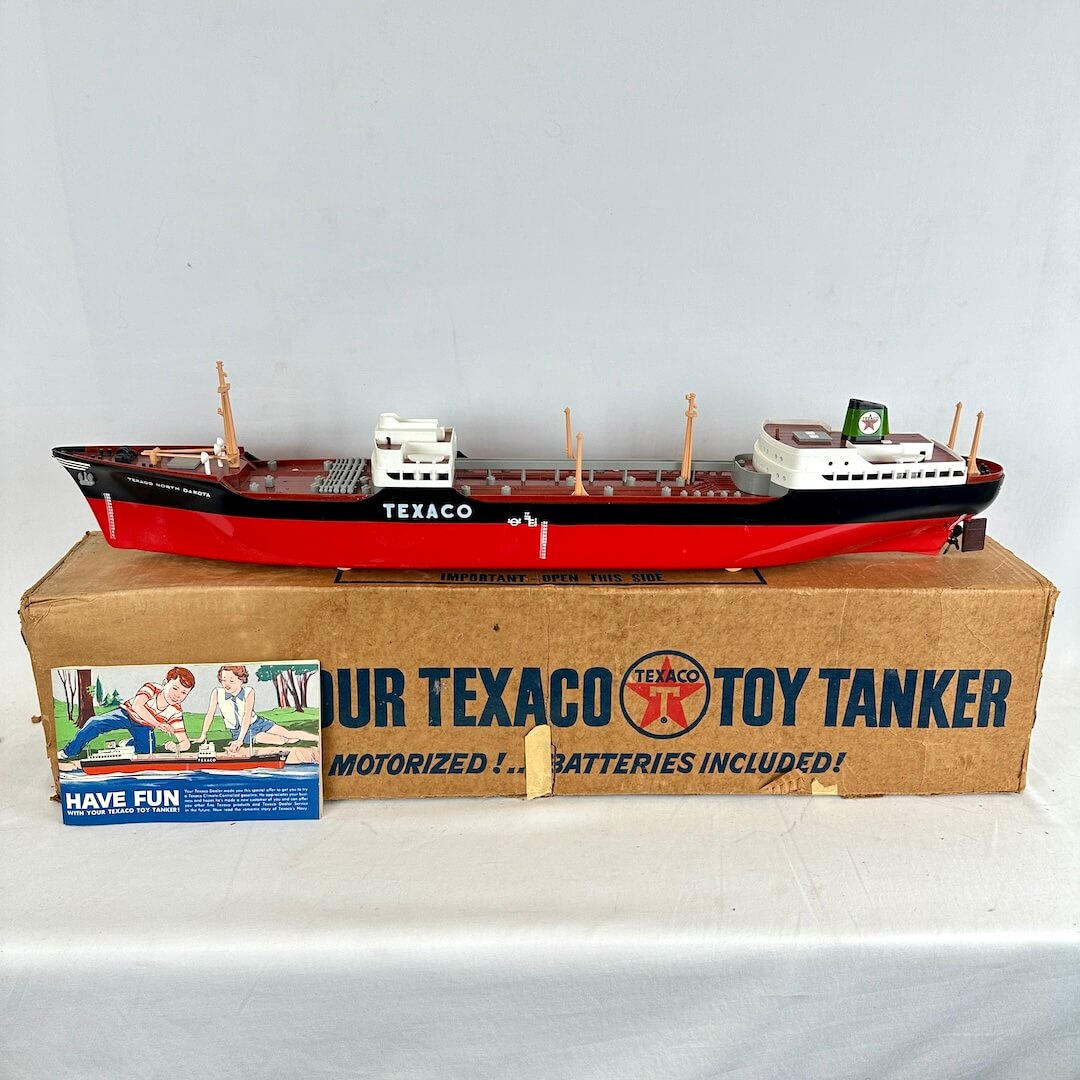 Model toy tanker ship on a cardboard box with Texaco branding