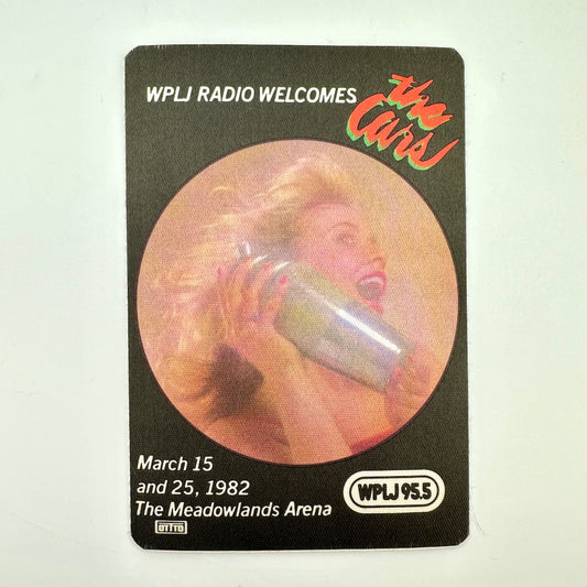 Fabric backstage pass with black background and image of woman on the phone in center. 