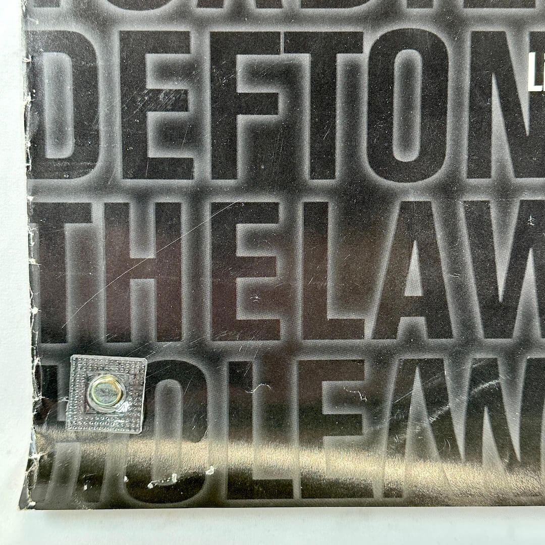 Bottom left corner with wear along edge and some scratches to surface, 