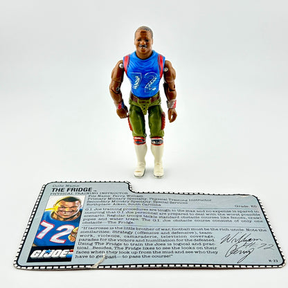 Action figure in blue shirt and green pants against white background.