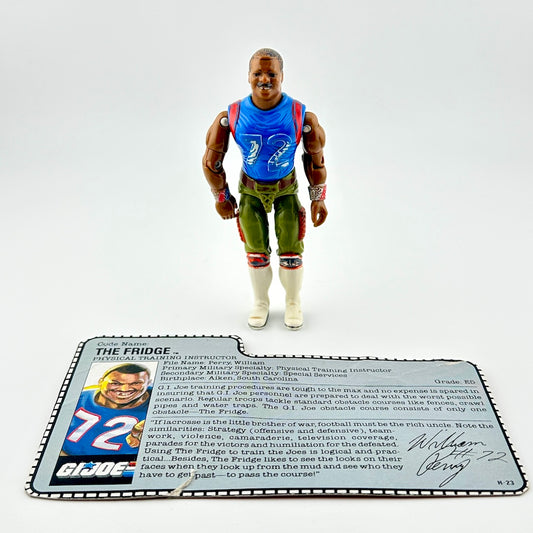 Action figure in blue shirt and green pants against white background.