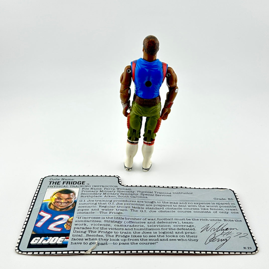 Action figure with blue top and green pants on a white background