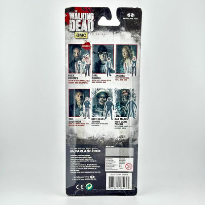 Back of a McFarlane Toys Walking Dead action figure blister card package, showing character photos, & product info.