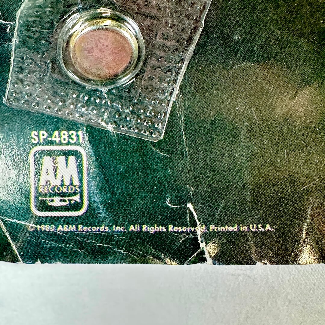 Close up of REcord company and poster information at bottom left corner. 