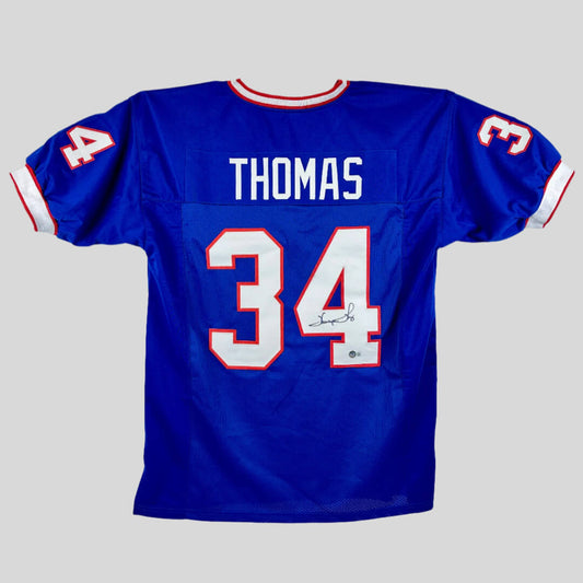 Blue sports jersey with 'THOMAS' and number '34' on a grey background