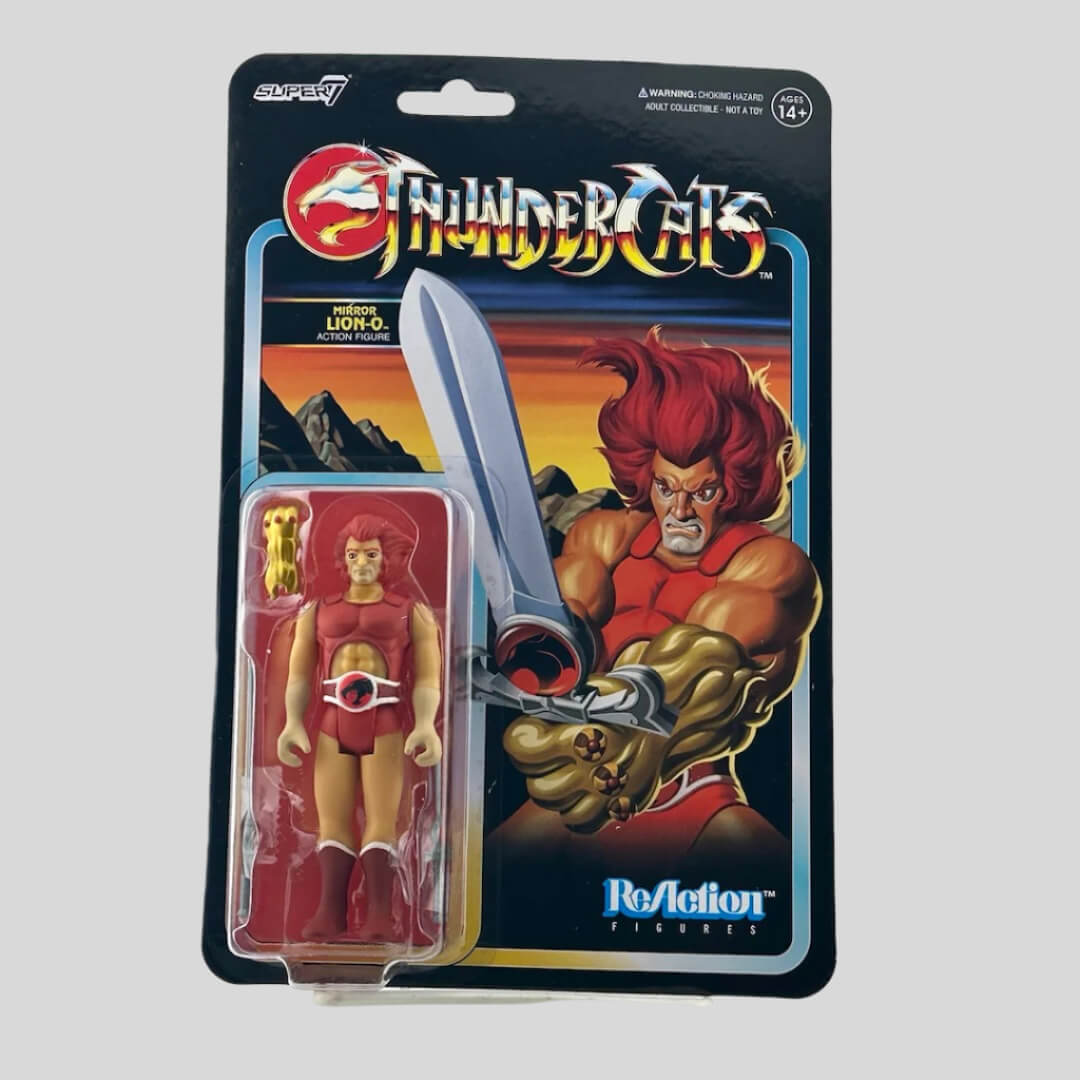 Front of package with illustration of character on back, and action figure in clear blister at left, comes with three accessories. 