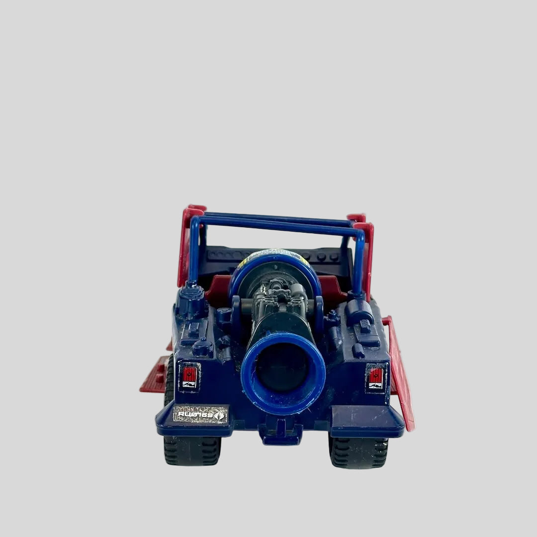 A vintage toy truck shown from the rear. The toy features a dark blue body, and red frame and accents.