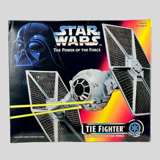Star Wars TIE Fighter toy packaging with Darth Vader helmet and Tie Fighter on a black background.