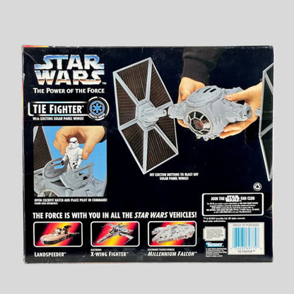 Star Wars TIE Fighter toy packaging with hands holding the toy on a white background