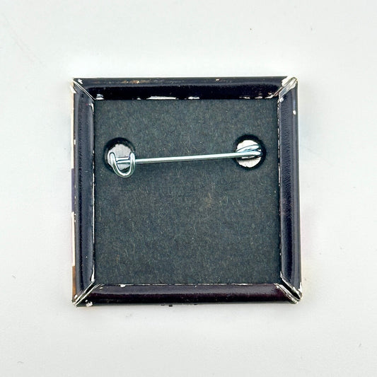 Backside of pin against white background. 