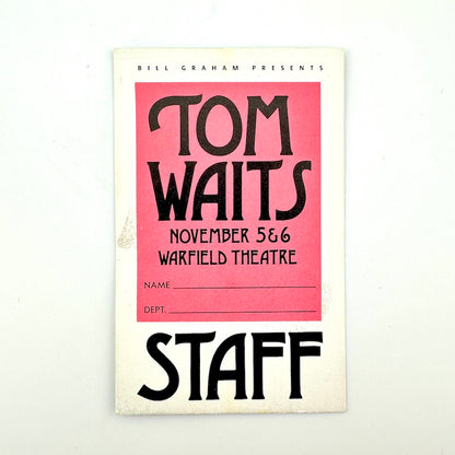 Vintage laminate card with white border, pink square in center with event details in black text. "STAFF" print at bottom. 