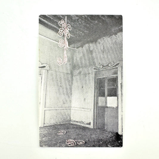 Backside of vintage laminate with black and white image of derelict room. 