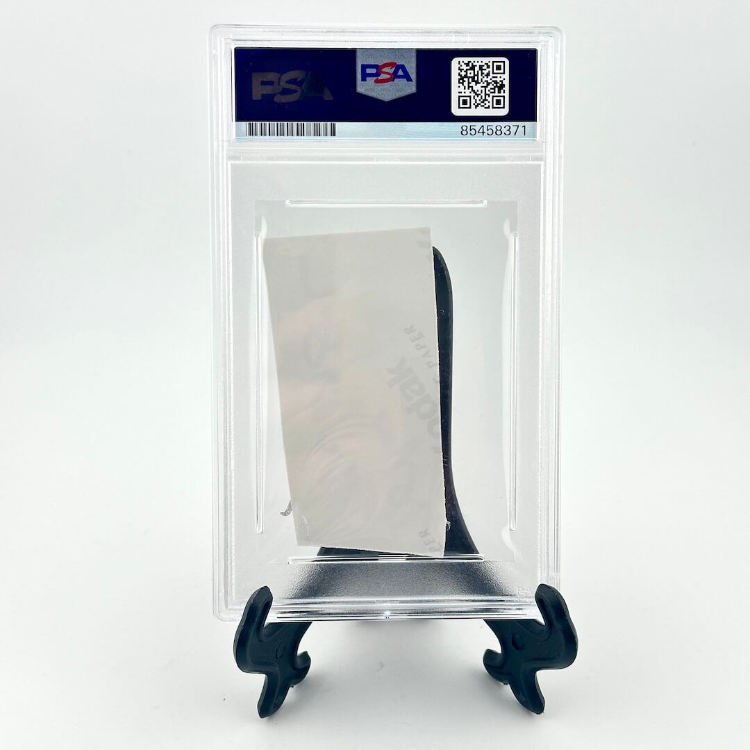 Card in a PSA protective case on a white background