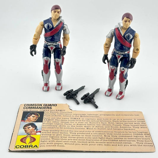 Two action figures with accessories and character card against white background. 
