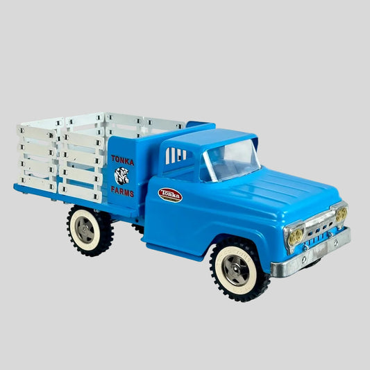 Blue toy truck with a white trailer on a light gray background