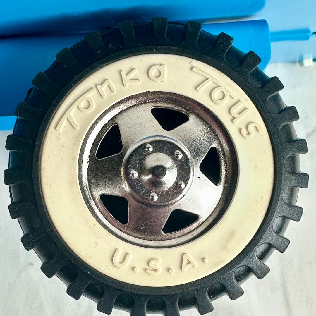Close-up of a toy wheel with 'Tonka Toys U.S.A.' branding on a white background.