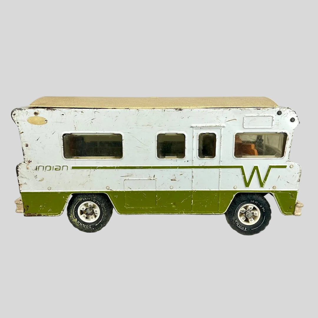 Model of a vintage camper with a white and green color scheme on a light gray background