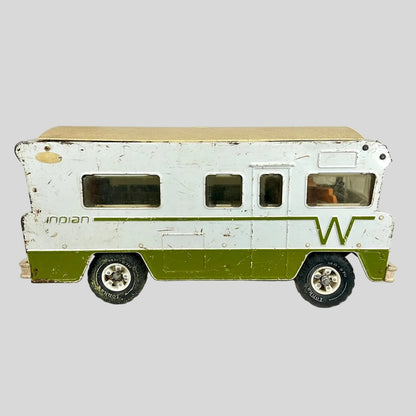 Model of a vintage camper with a white and green color scheme on a light gray background