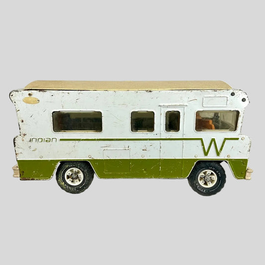 Model of a vintage camper with a white and green color scheme on a light gray background