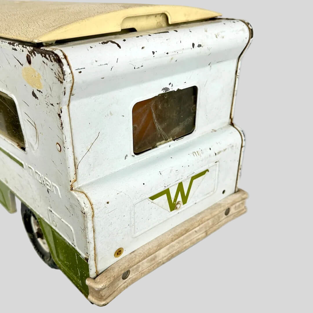 Vintage toy truck with a white body and green base on a white background
