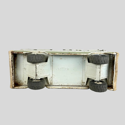 Vintage toy truck with visible wear on a white background