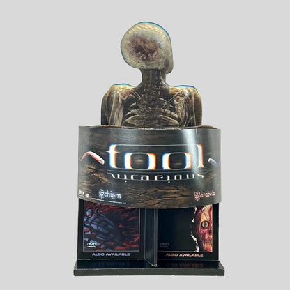 Retail display stand for TOOL "Vicarious" single and two other albums on light background. 