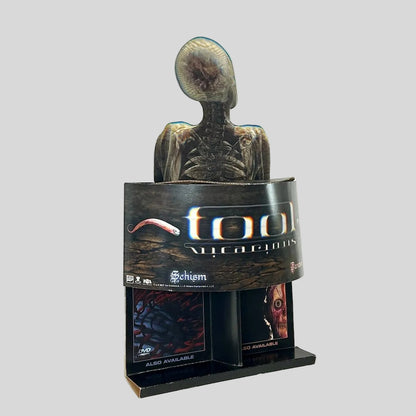 Side view of retail stand up display for TOOL with banner of single name under human skeleton design. 