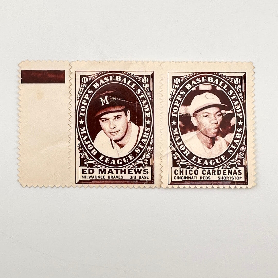 Two vintage baseball player stamps on a cream-colored paper strip against a light gray background. 