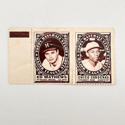 Two vintage baseball player stamps on a cream-colored paper strip against a light gray background. 
