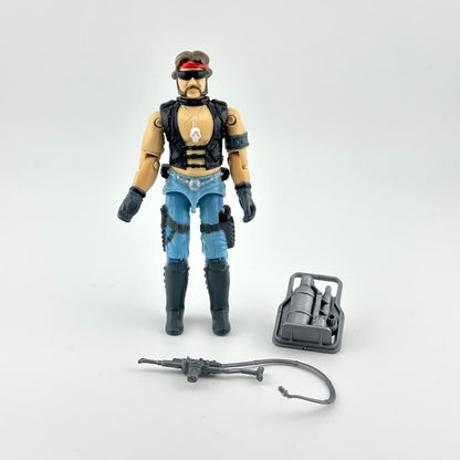 GI Joe action figure with accessories against white background. 