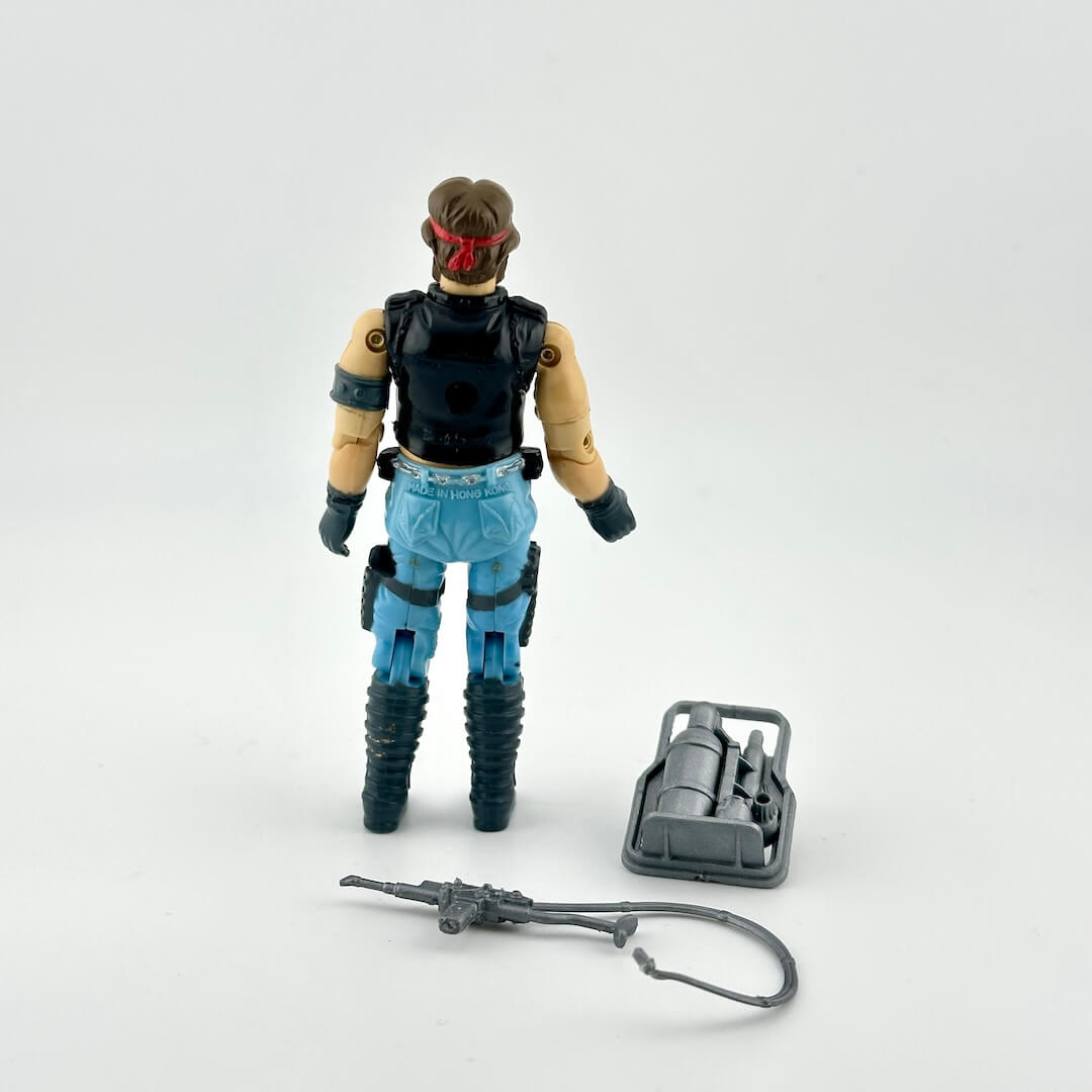 GI Joe action figure with accessories against white background. 