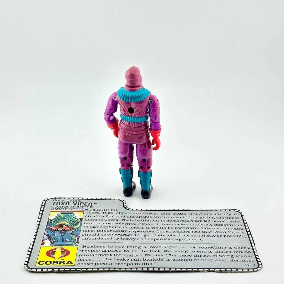 Toy figure of Toxo Viper with a card detailing its features on a white background