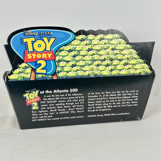 Back of Hot Wheels/Toy Story car set with images of green aliens and product description. 