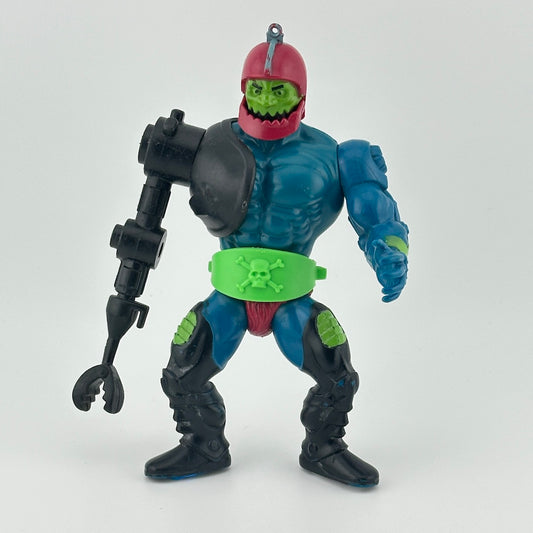 Mostly blue male figure with black robotic arm, green face, green skull & crossbones belt, red helmet with jaw articulation.