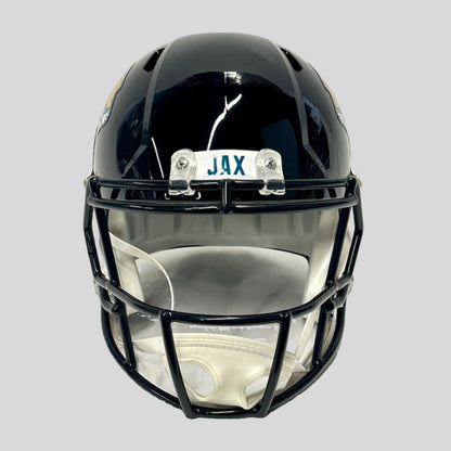 Black football helmet with 'JAX' above. face against gray background.