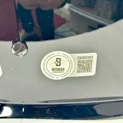 Close-up of a 'Witness Autograph' label on back of helmet. 