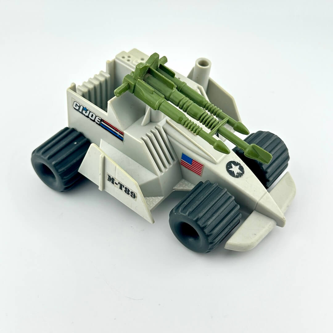 Toy military vehicle with green missiles on a white background
