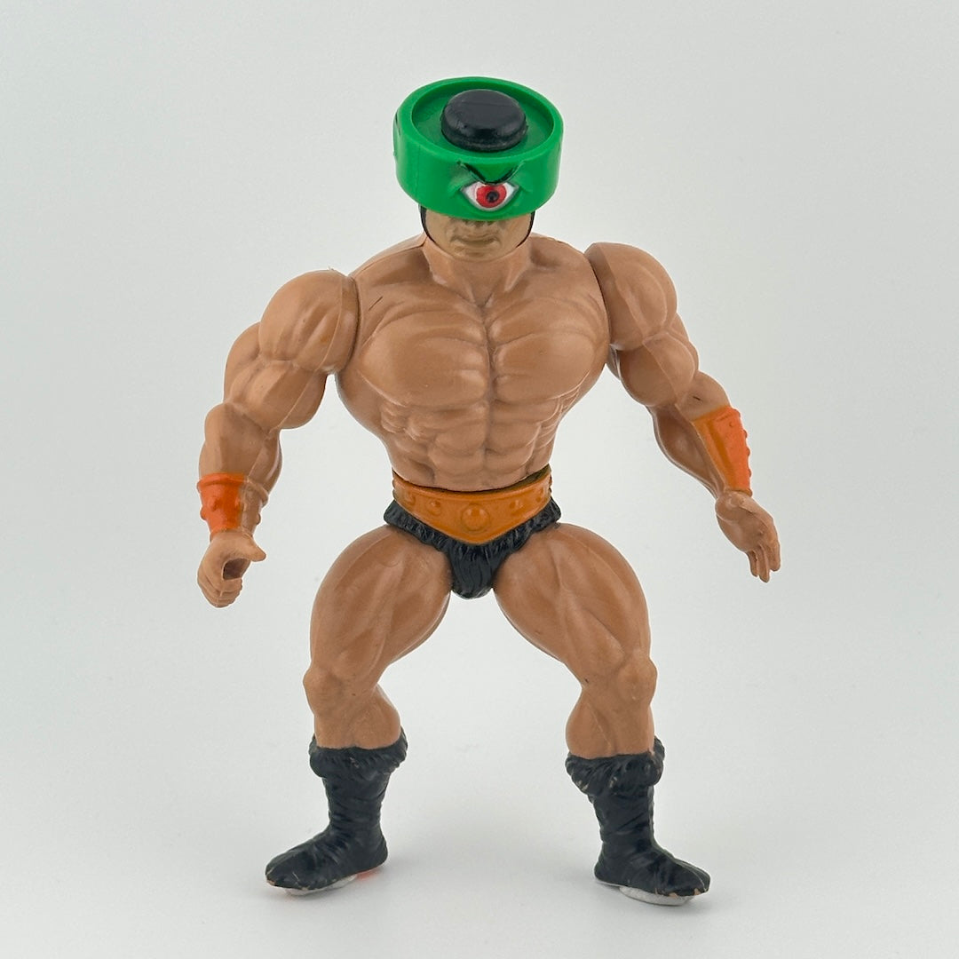 White male action figure with green visor that turns to show different eyes wearing black loincloth & boots, belt & gauntlets