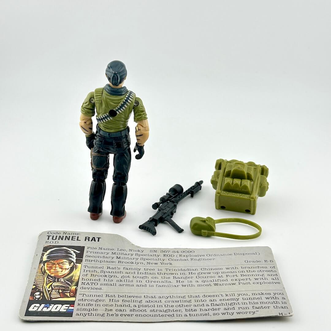 Toy figure of a Tunnel Rat with accessories and card on a white background
