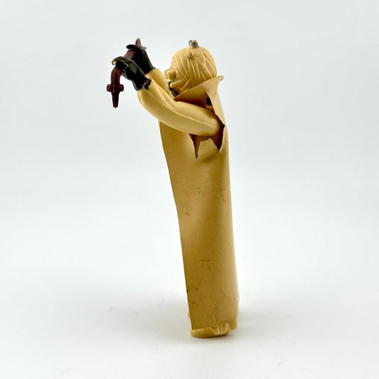 Side view of action figure in beige holding staff on white background. 