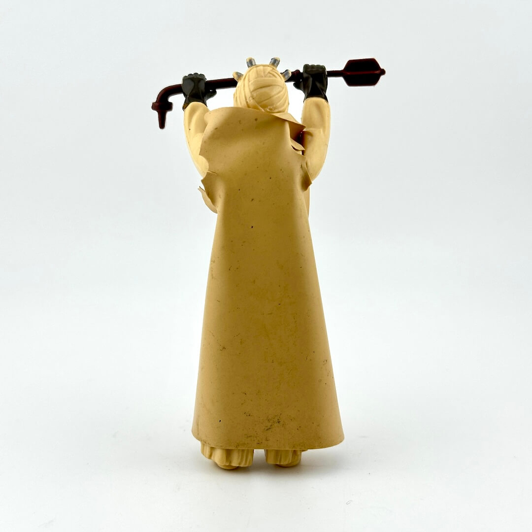 Figure in a long beige robe holding staff on a white background